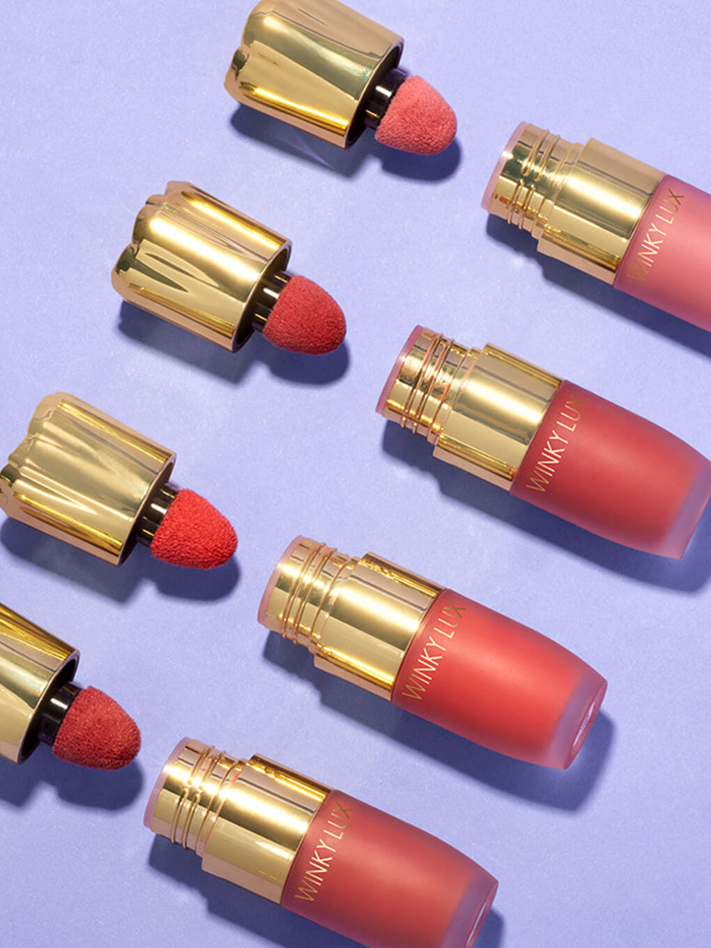 noble -- 4 shades of cheeky rose liquid blush caps off lined up flat lay