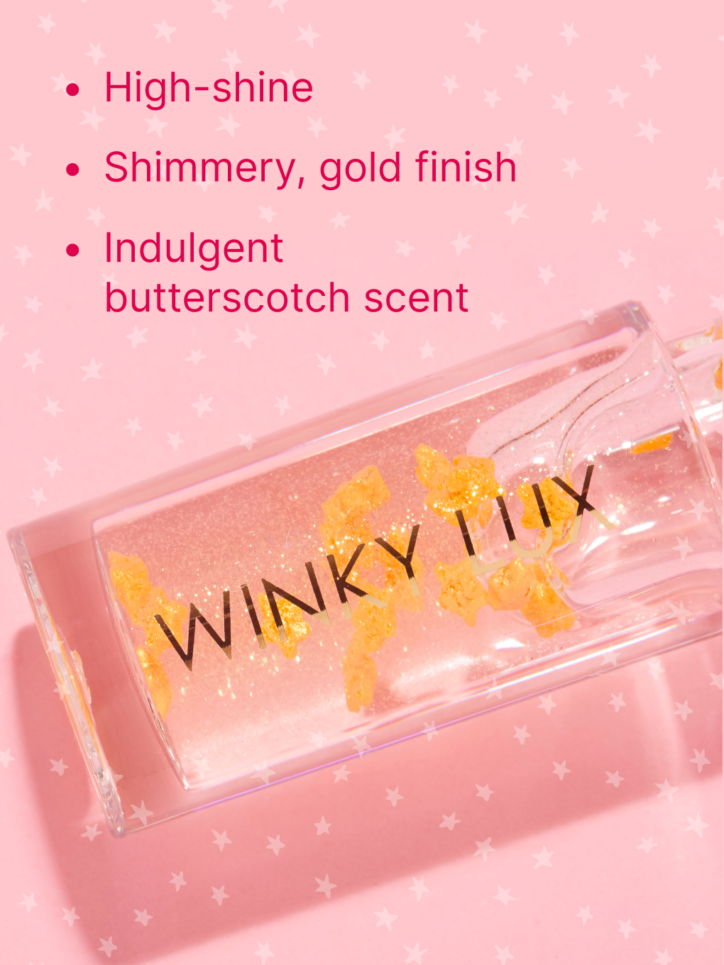 in the stars nourishing lip oil applicator resting on top of bottle on pink background